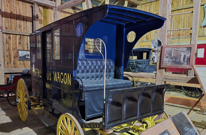 Image of a horse drawn Rural U.S. Mail delivery wagon on display at the Farm Museum