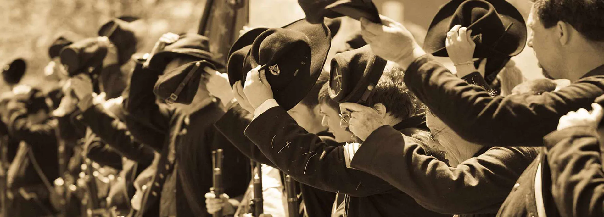 Image of civil war reenactor in line cheering with their hats off