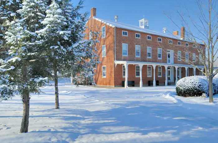 Image of the Farm Museum Almshouse in the snow